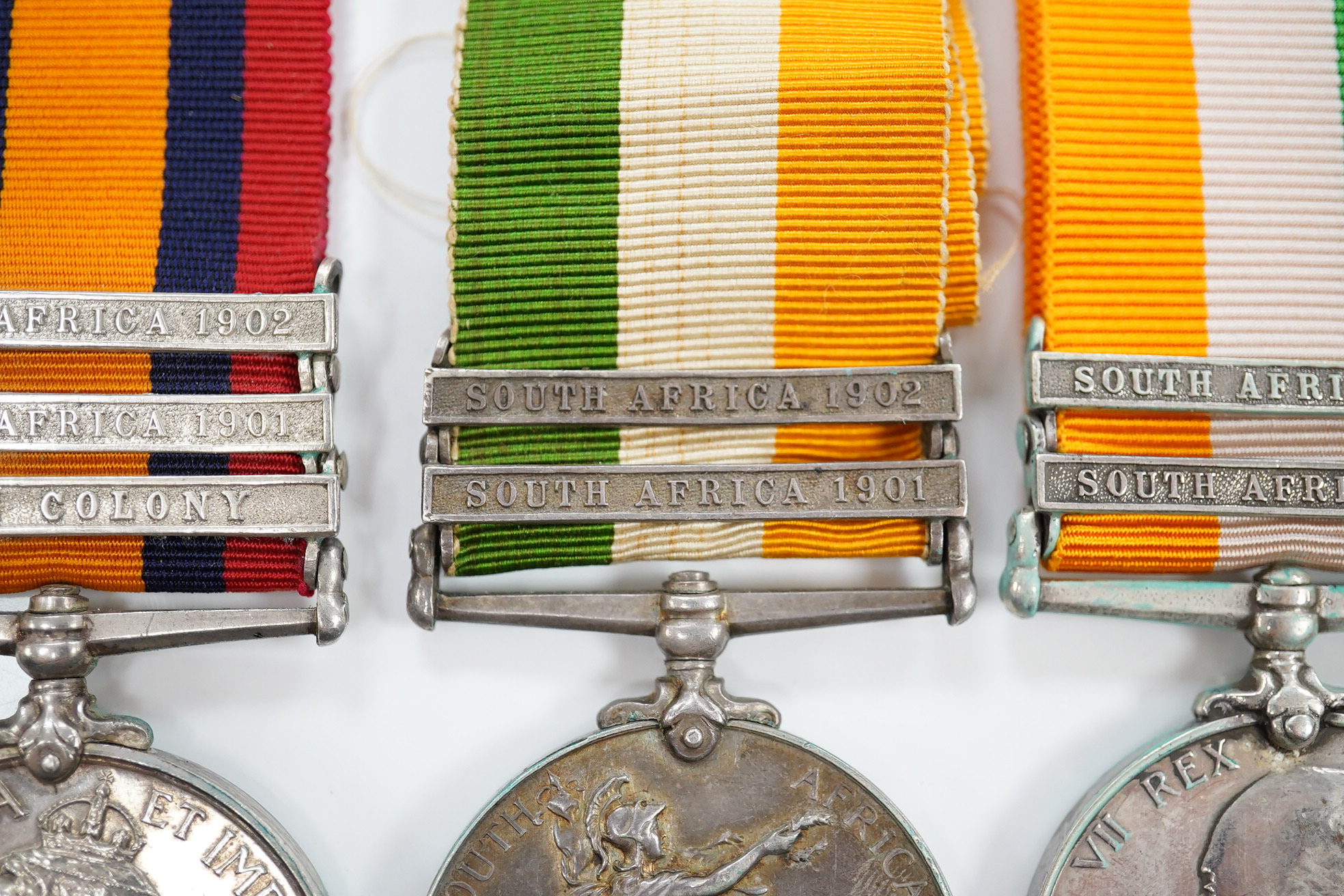 A Queen's South Africa Medal with Laings Nek, Belfast and OFS clasps to 12036 Bomr M.Miller R.F.A.Arty, another unnamed with 1901, 1902 and CC clasps, and two King's South Africa medals both with 1901/1902 clasps to 6408